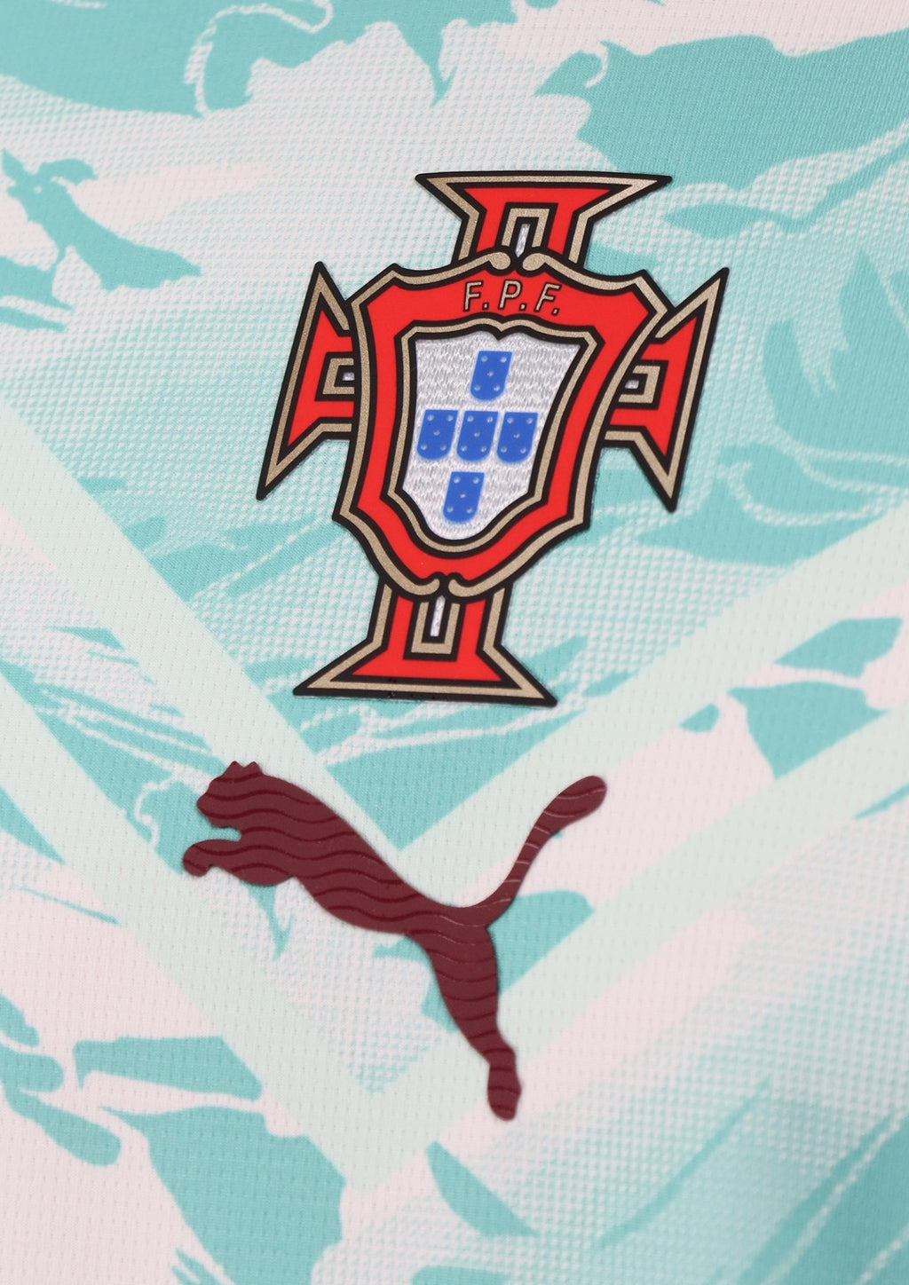 Portugal Training/Pre-Match 2024 : Blanc et vert menthe avec un motif de vagues dynamiques sur tout le torse et le blason de la fédération au centre. GoalKits