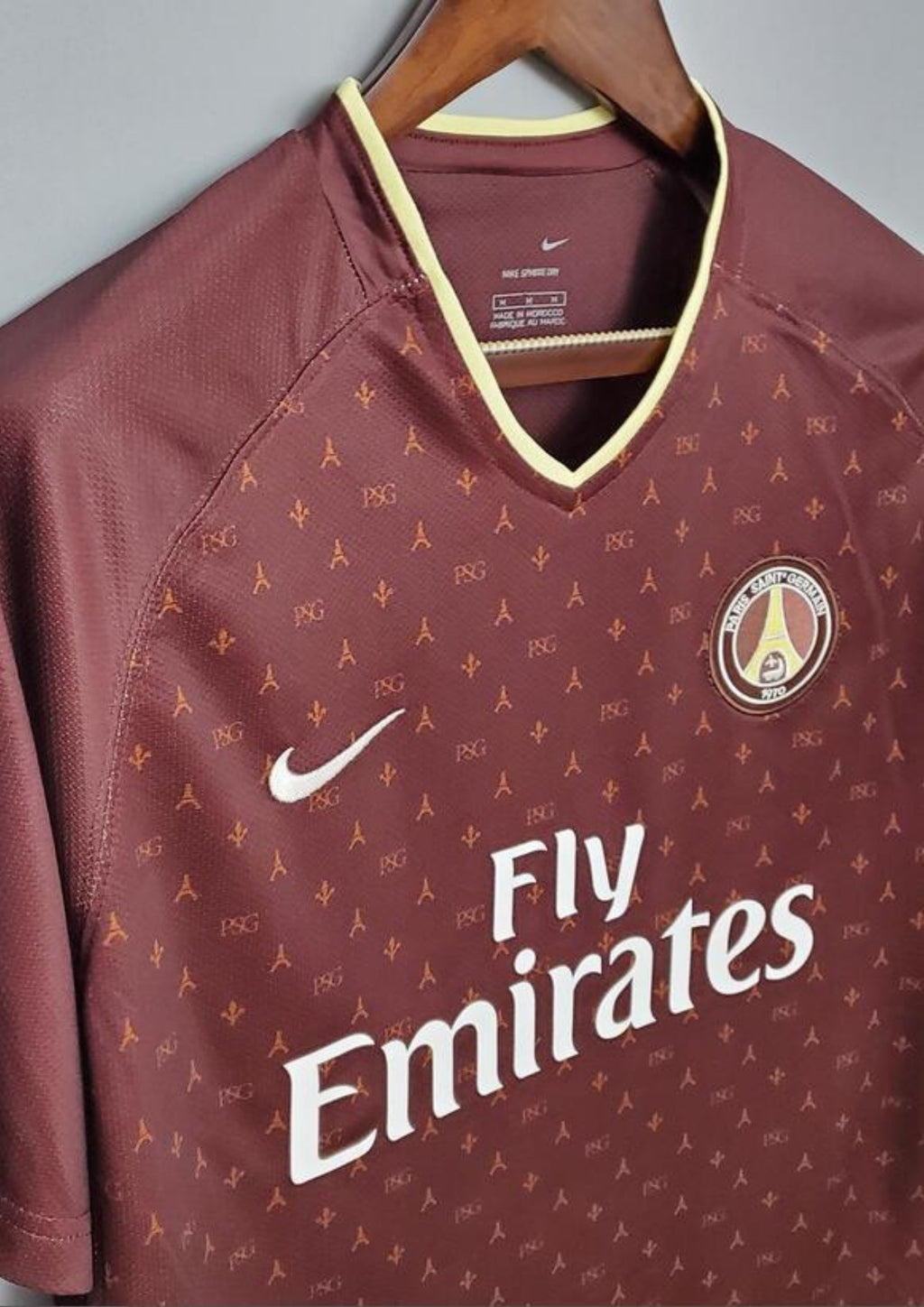 Paris Saint-Germain bordeaux monogramme : maillot couleur prune/bordeaux avec un motif monogramme "PSG" et Tour Eiffel sur tout le torse, col en V et liserés jaune pâle, sponsor Fly Emirates. GoalKits