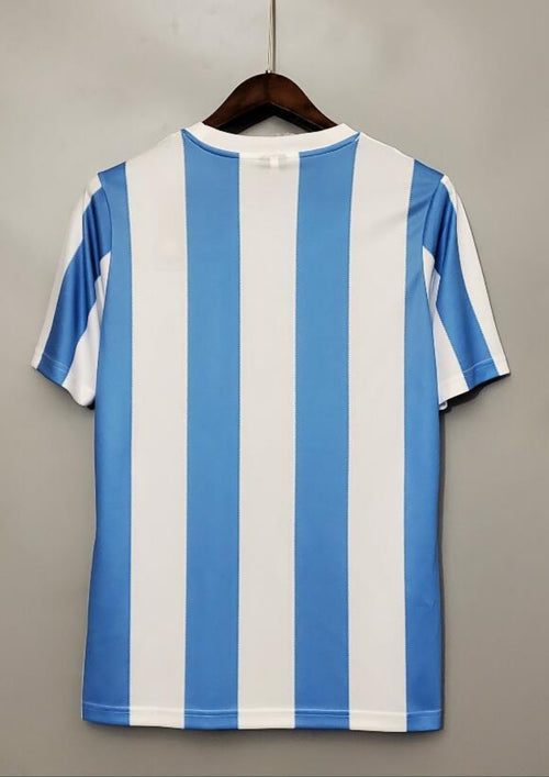 Argentine 1986 (Domicile) Rayures verticales ciel et blanc, logo Le Coq Sportif noir, écusson AFA classique brodé. GoalKits