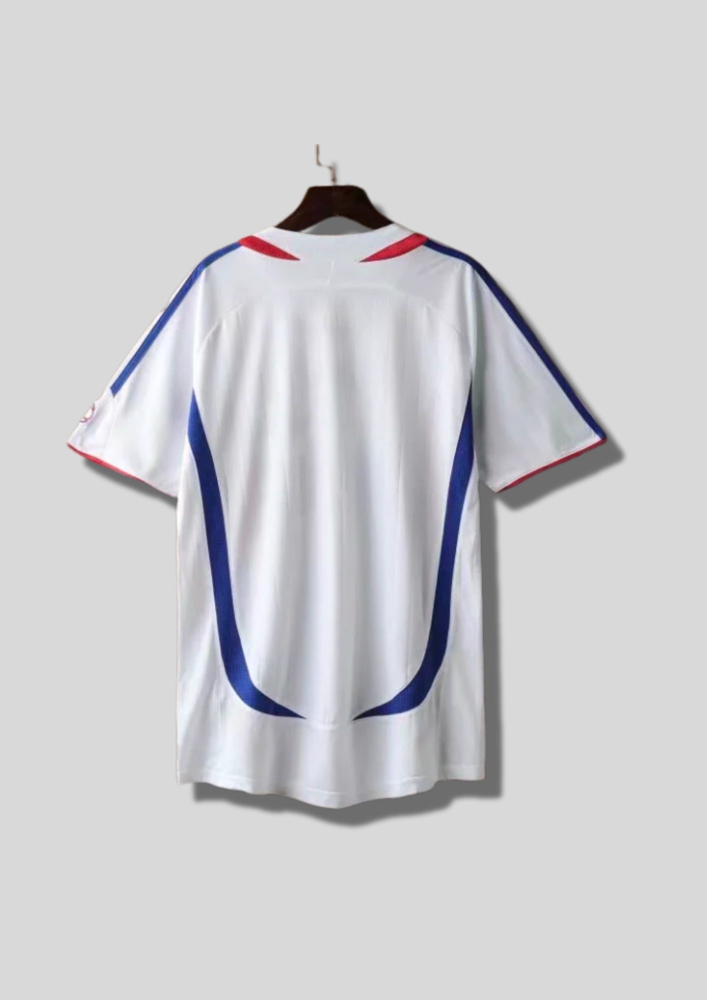 France Extérieur 2006 : Blanc, bande centrale tricolore dégradée, détails rouges courbés. GoalKits